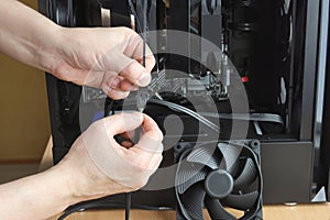 Computer cooling system fan, arms connect power connector in system unit