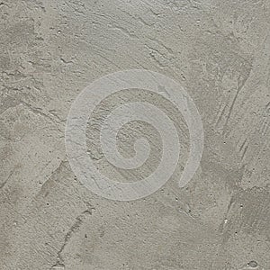 A textured surface of gray concrete with visible trowel marks and subtle patterns. The