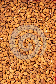 Trade counter with peeled almond nuts. Textured surface. Autumn agricultural fair.