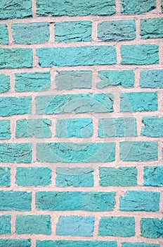 Textured wall of light blue dark bricks, detailed background
