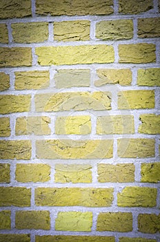 Textured wall of yellow bricks, detailed background