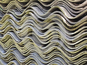 Textured wavy sheets of slate. Old roofing slates storage. Corrugated asbestos-cement sheets