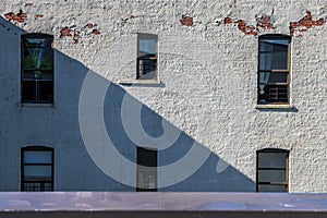 Textured white brick wall and windows on a sunny afternoon in the Bronx, New York City, NY, USA