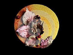 Textured yellow autumn cake with fresh cranberries and chocolate leaves decorations