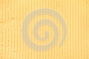 textured yellow background with plaster vertical lines and stripes