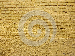 Textured yellow brick wall