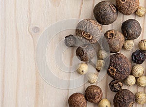 Textures and backdrop with dried peppers on a light wooden background.