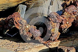 Textures and shapes in rocks with a rusted chain