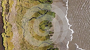 textures and veins cutting thru the wetlands of a tidal river system in Tasmanias Swan river area, Australia