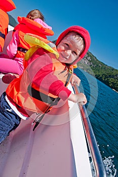 TFloating toddler boy in a boat