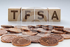 TFSA letters on wooden blocks with coins on a clear background