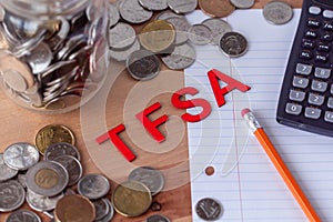 `TFSA` Tax Free Savings Account signs with coins in the background