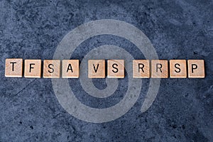 `TFSA vs RRSP` spelled out in wooden letter tiles