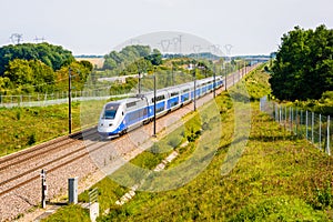 A TGV high speed train driving in the french countryside