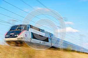 A TGV high-speed train in the french countryside with motion blur