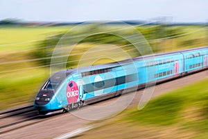 A TGV Ouigo high speed train with motion blur