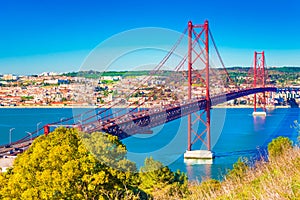 The 25th April Bridge Ponte 25 de Abril in Lisbon, Portugal. View from Almada photo