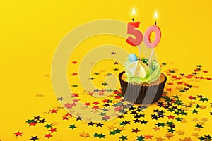 50th birthday cupcake with candle and sprinkles