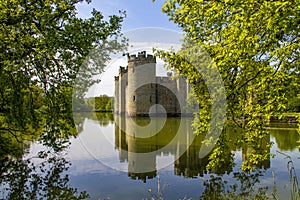 14th century Bodium castle surrounded by a moat in the County of Sussex in England.