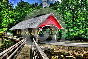 19th Century covered bridge with a wooden walk along side of it HDR.