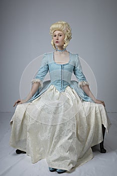 18th century woman with a blonde wig and blue gown photo