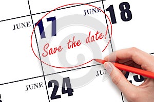 Hand drawing red line and writing the text Save the date on calendar date June 17. photo