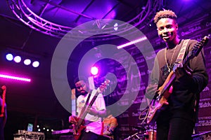 Two guitarist entertaining  during a  concert