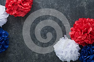 4th of July background. USA paper fans, Red, blue, white stars, balloons, gold confetti on gray dark concrete background. Happy