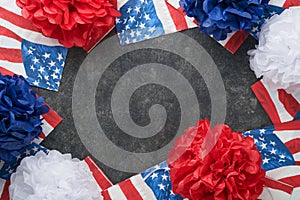 4th of July background. USA paper fans, Red, blue, white stars, balloons, gold confetti on gray dark concrete background. Happy