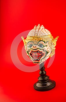 Thai actor's mask on red background photo