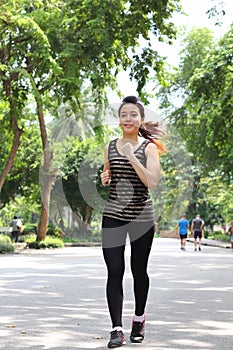 Thai adult beautiful girl doing running exercises in the park