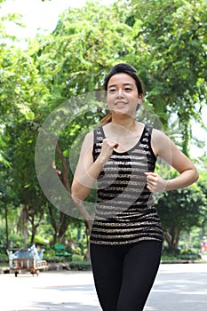 Thai adult beautiful girl doing running exercises in the park