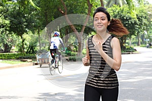 Thai adult beautiful girl doing running exercises in the park