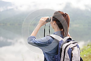 Thai adventure girl wathcing with binoculars