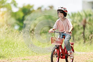 Thai Asian kid girl riding bicycle