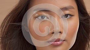 Thai asian model with natural makeup on beige background