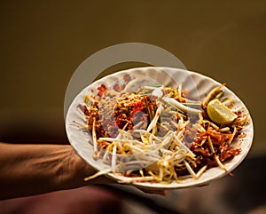 Thai Asian street fast food in hot pan, Pad Thai, or phad thai is a stir fried rice noodle dish commonly served as a street food