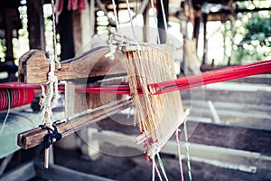 Thai Asian Style Vintage textile thread wooden machine to make traditional clothing and fabric pattern weaving