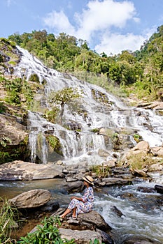 Thai Asian women visit Mae Ya Waterfall Doi Inthanon national park Thailand Chiang Mai