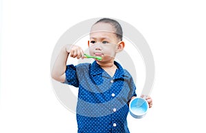 Thai baby boy brushing teeth. In baby hand holding cup