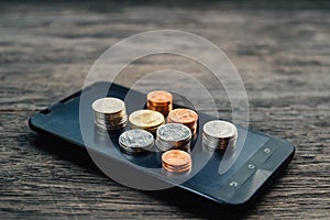 Thai Baht Coins and money on smart phone