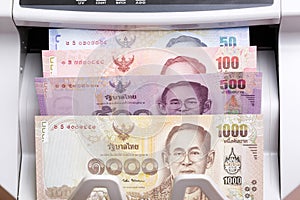 Thai baht in a counting machine photo