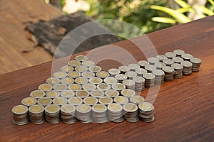 Thai Baht lots coin Arranged in arrow shape on with blurred background texture, Money stack for business planning investment