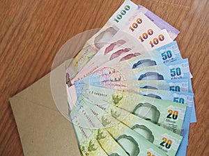 Thai Baht Money, arranged banknotes in brown envelope