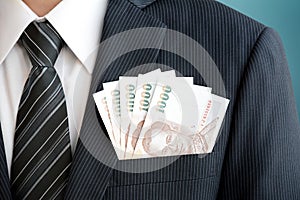 Thai baht (THB) money in suit pocket