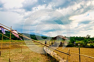 Thai bamboo walking path and bridge with beautiful sky and forrest background