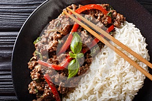 Thai Basil Beef, or Pad Gra Prow with rice side dish close-up. horizontal top view photo