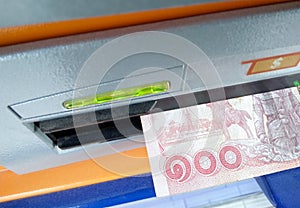 Thai Bath Cash on the Money Slot of an ATM Machine