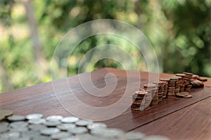 Thai bath coin 25 satang lots on wooden table with blurred background, Money of Thailand, Investment and saving concept, Money