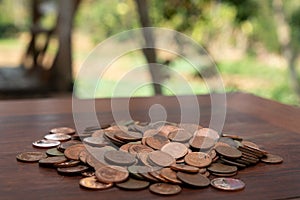 Thai bath coin 25 satang lots on wooden table with blurred background, Money of Thailand, Investment and saving concept, Money